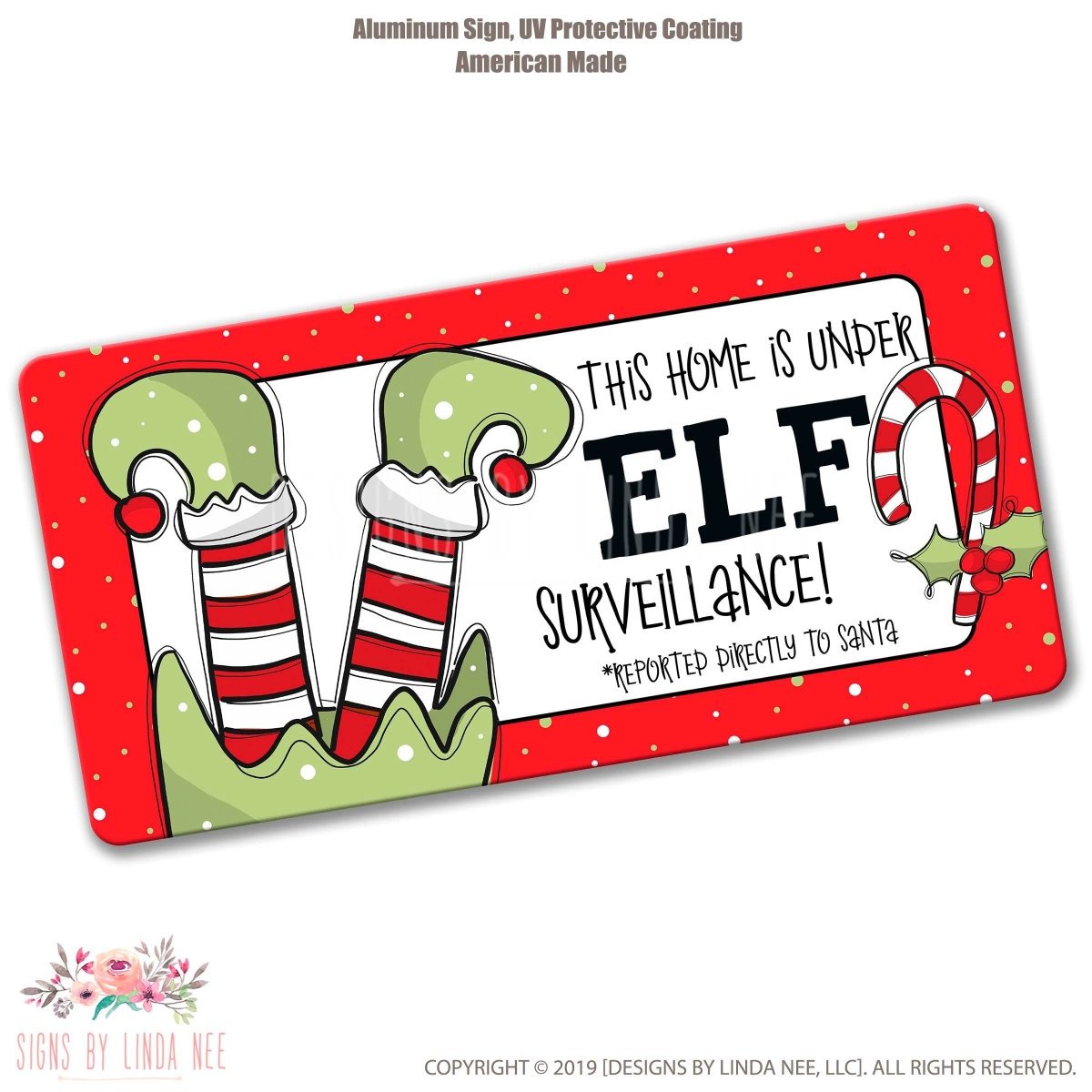 The image is an aluminum sign with a red border and a festive design featuring a Christmas tree and two green elf ears. The sign has a humorous message about the home being under surveillance.