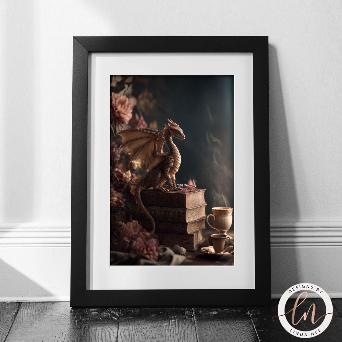 A framed image depicting a dragon perched on a stack of books, with a cup of tea nearby, set against a backdrop of pink flowers.