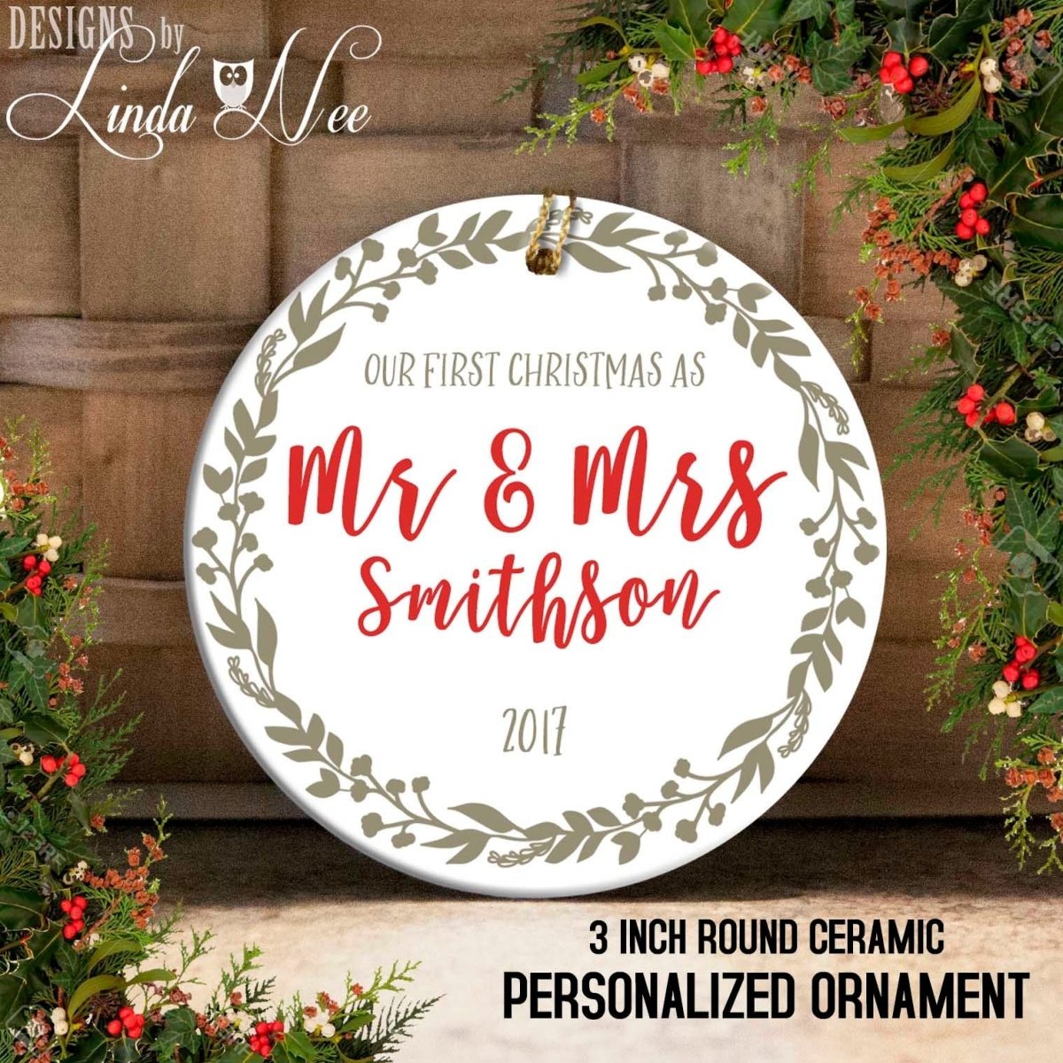 A round ceramic ornament with the text "Mr & Mrs Smith" and "Our first Christmas as" written on it, surrounded by a wreath design. The ornament is described as a 3-inch round ceramic personalized ornament.