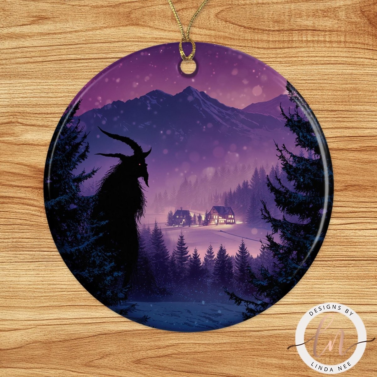 A circular ornament featuring a nighttime landscape with a silhouetted figure, a snowy mountain, and a village in the distance.