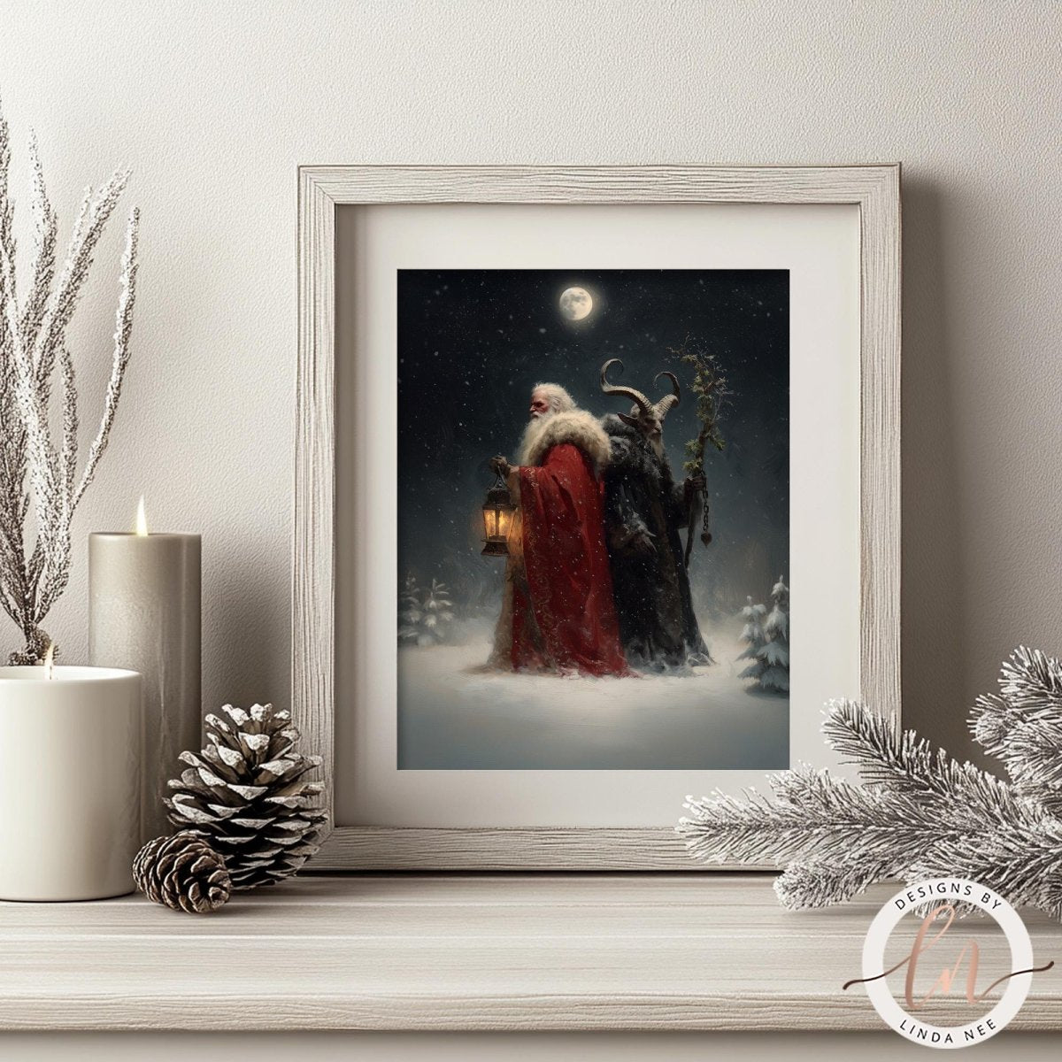 a framed painting depicting a snowy night scene with two figures, one wearing a red robe and the other a black robe, standing in the snow. The painting is framed in a white wooden frame and is placed on a shelf next to a pine cone and a candle.