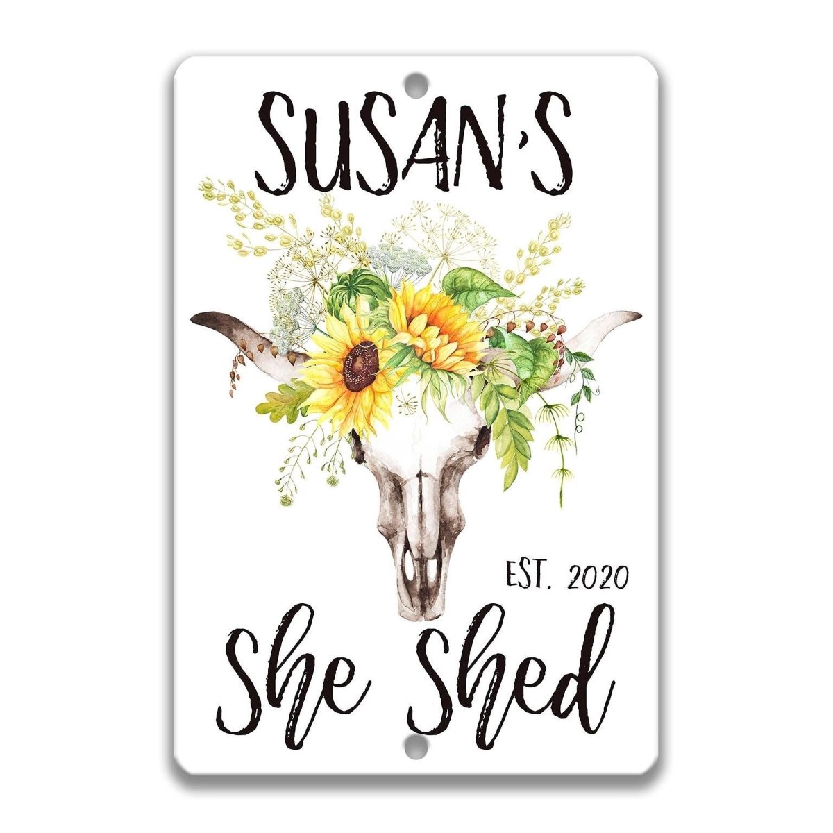 a sign with a stylized cow's head and sunflowers, along with the text "SUSAN'S She Shed" and "EST. 2020".