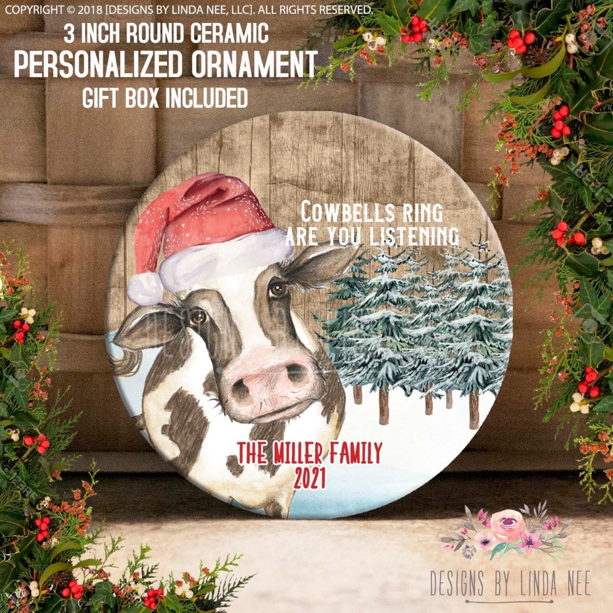 Round ceramic personalized ornament with cow design and Christmas elements, surrounded by festive decorations.