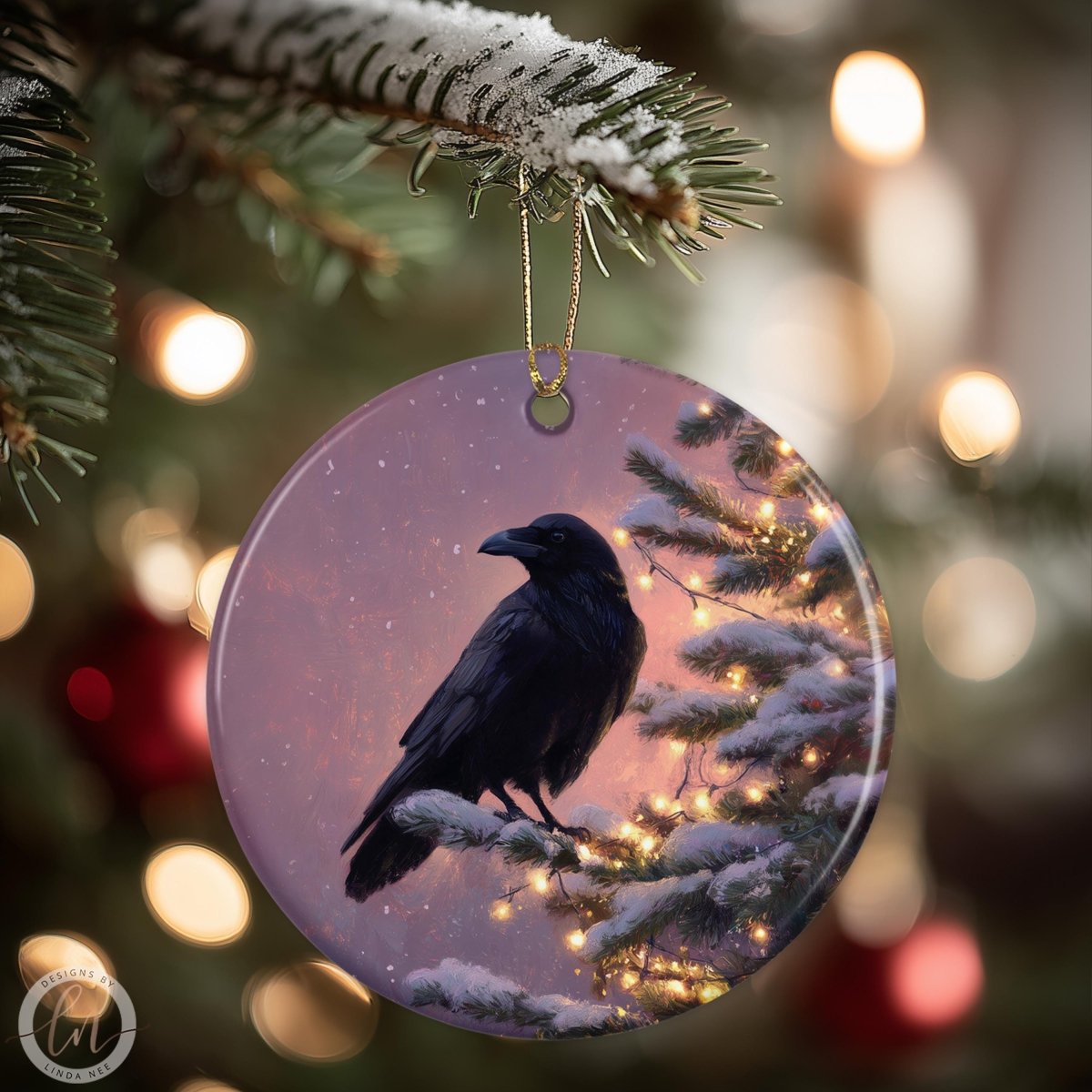A black bird is perched on a snowy branch, with a purple and pink background, and Christmas lights visible in the background.
