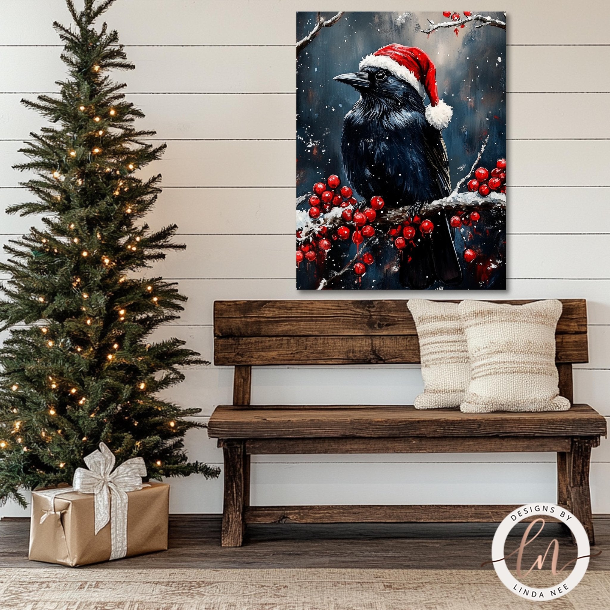 a wooden bench with two pillows, a Christmas tree with twinkling lights, and a framed painting of a black bird wearing a Santa hat, all set against a white wall.