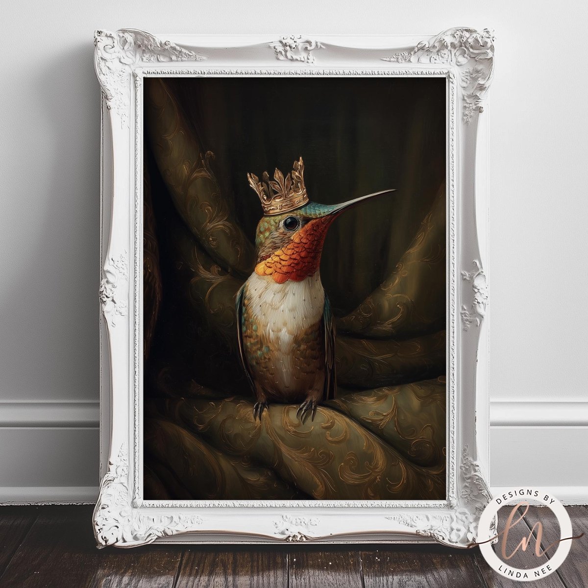 A framed painting of a colorful hummingbird wearing a golden crown, sitting on a green fabric background.