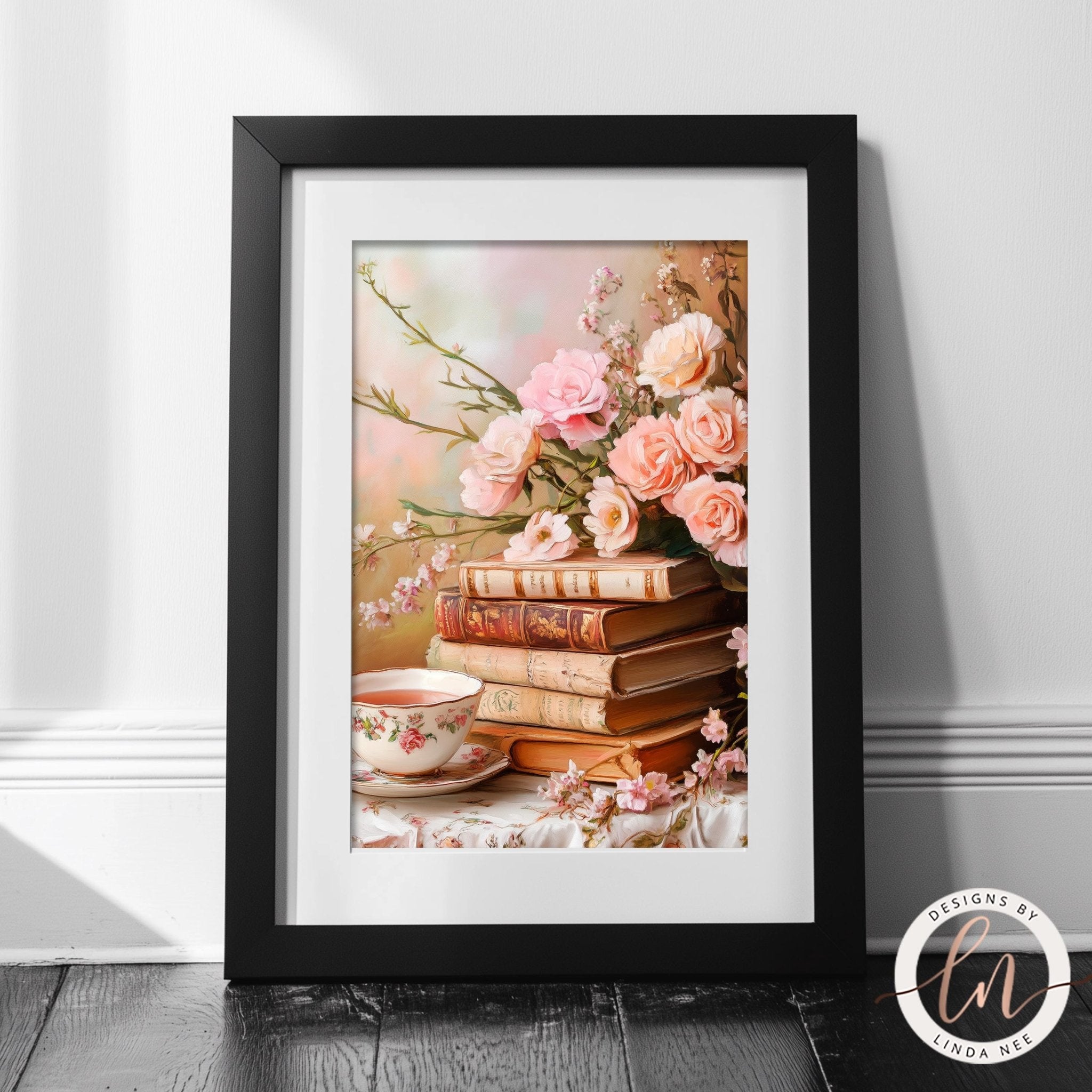 A framed image of a stack of books with a vase of pink roses and a teacup on a table, set against a blurred background.