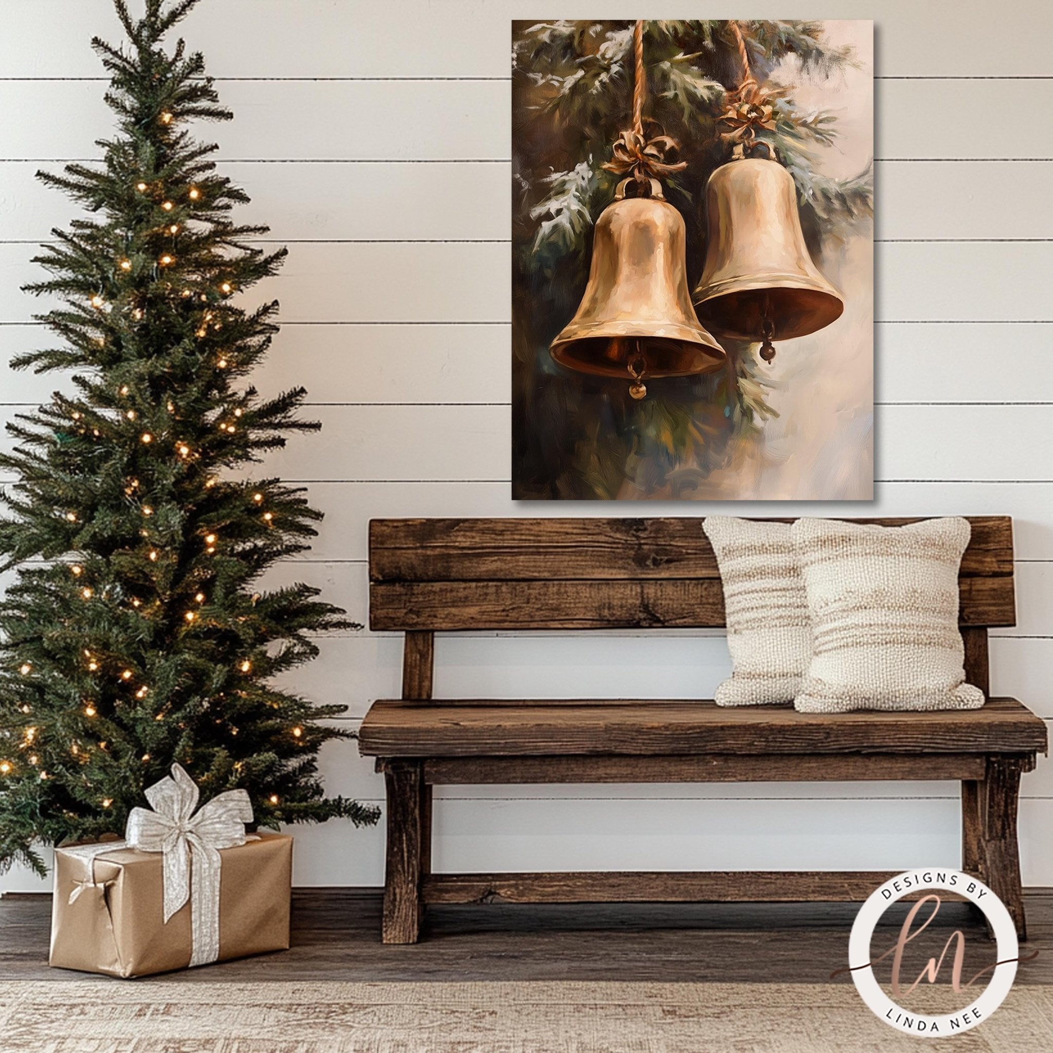 a cozy Christmas scene with a lit Christmas tree, a wooden bench with a white pillow, and a framed painting of two golden bells hanging on a wall.