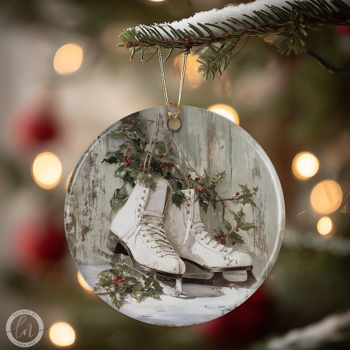 A round ornament hanging from a tree branch, featuring a pair of white ice skates surrounded by holly leaves and berries.