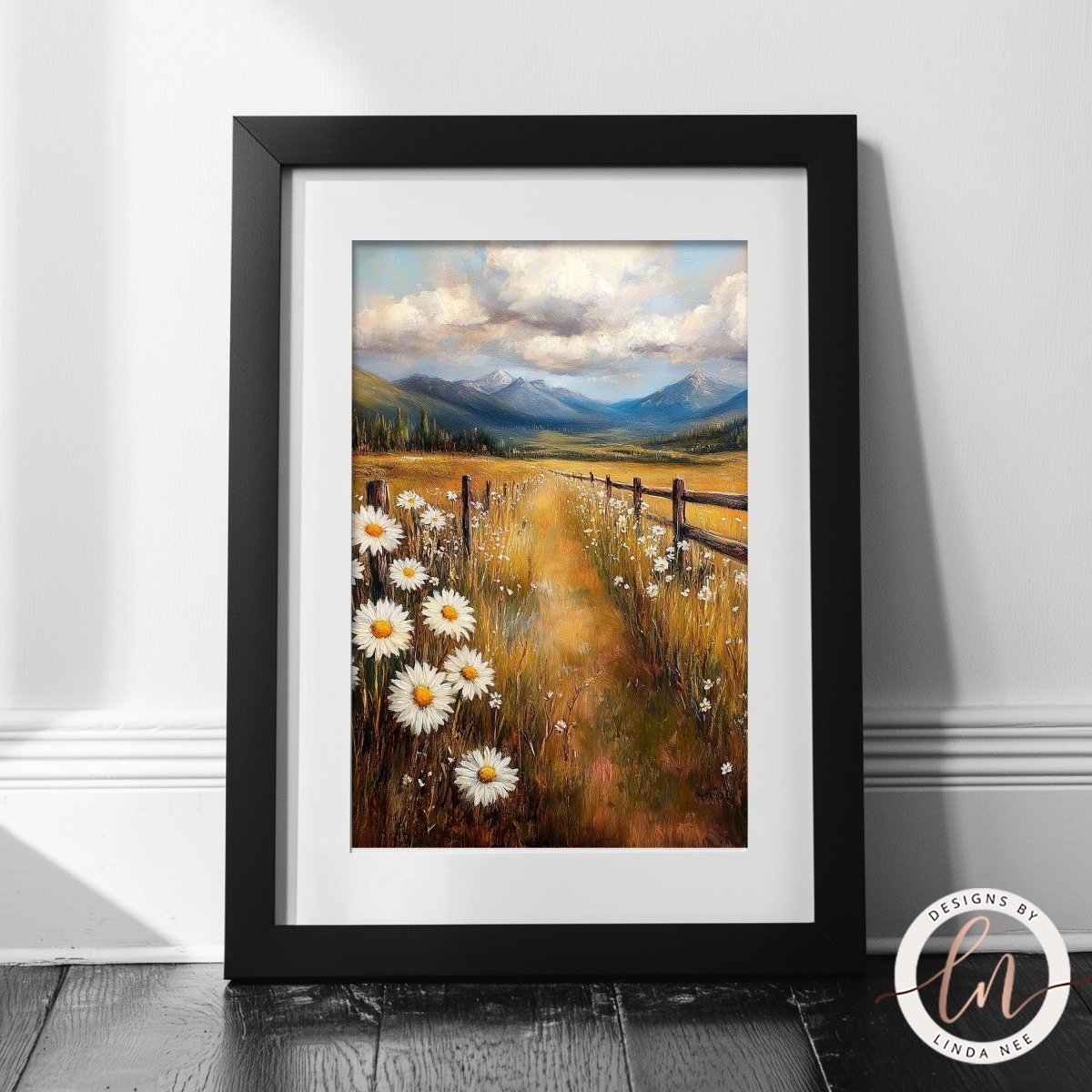 A framed painting depicting a scenic countryside landscape with a field of white daisies, a wooden fence, and mountains in the distance.