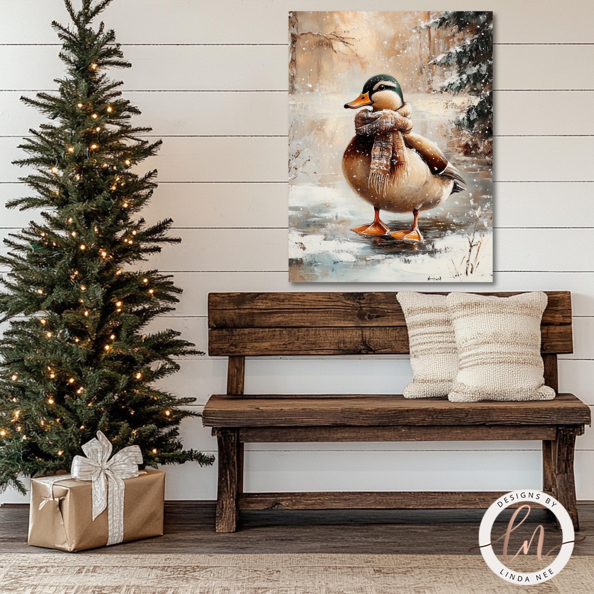 a wooden bench with two white pillows, a Christmas tree with twinkling lights, and a painting of a duck wearing a scarf on the wall above the bench.