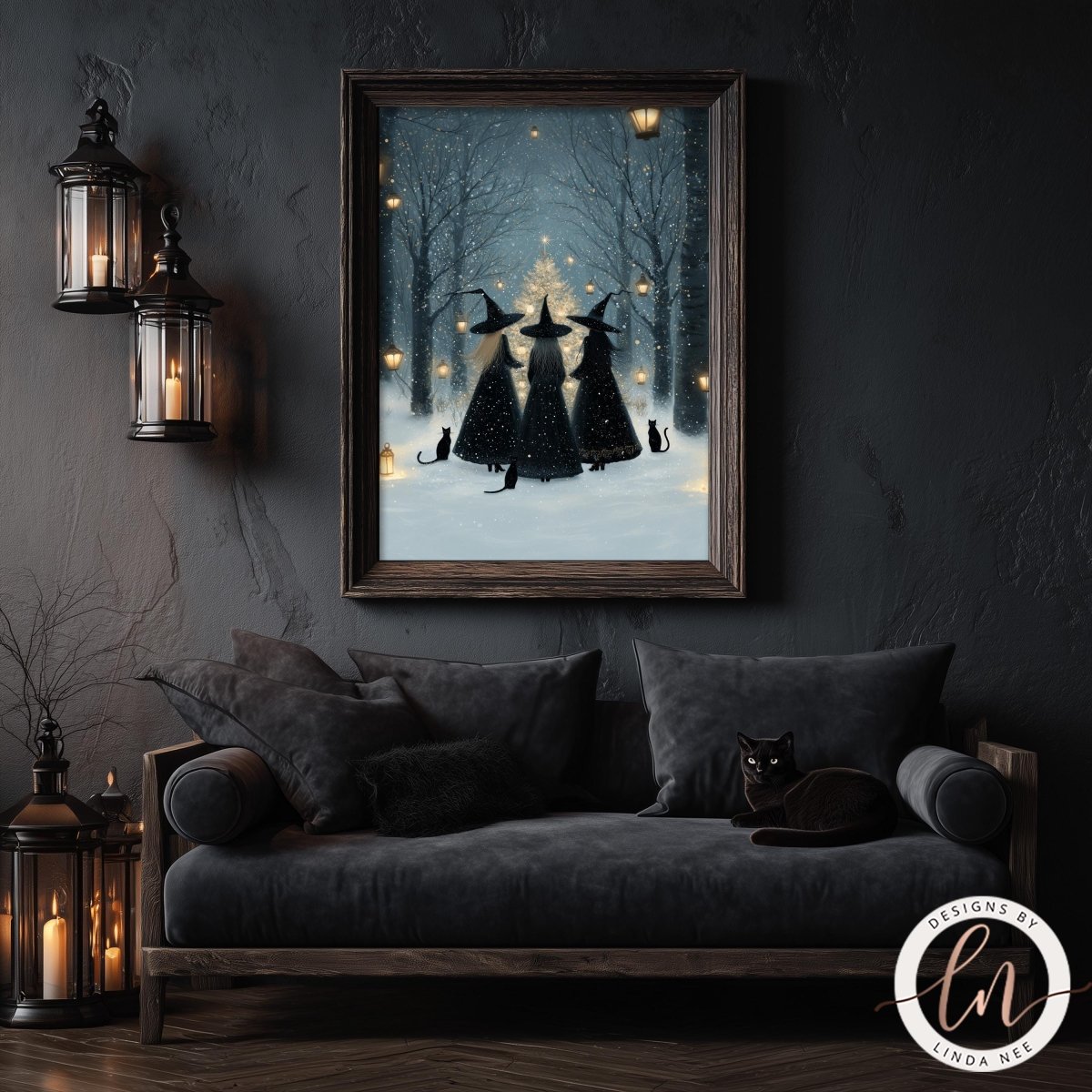 a cozy living room with a black sofa and a framed picture of three black cats sitting in the snow, surrounded by trees and lit candles.