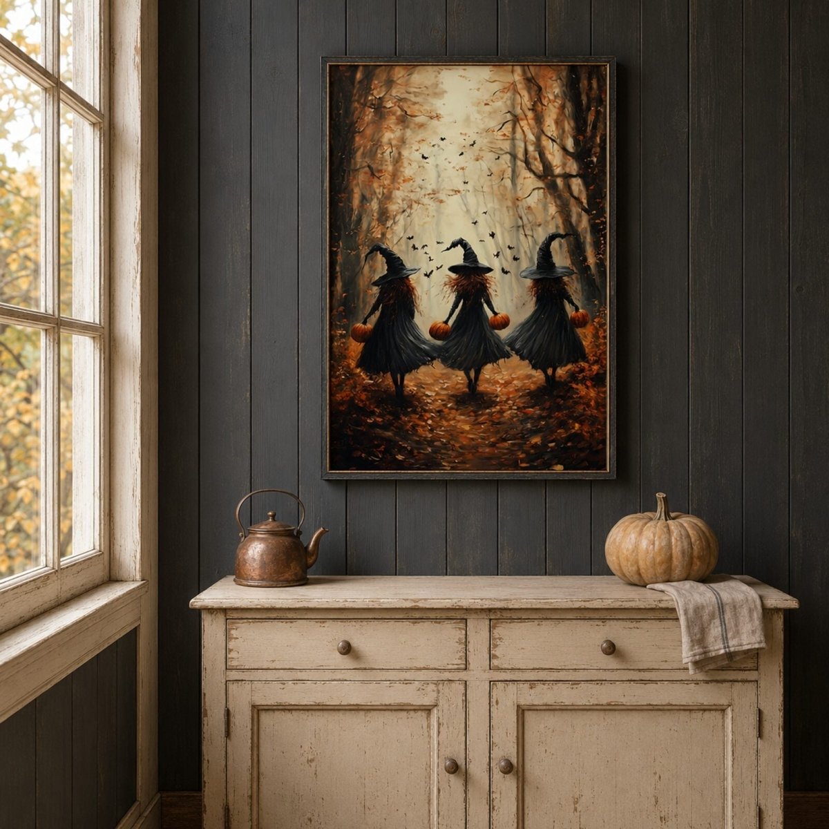 Framed fall witches art print displayed above an antique cabinet in a rustic farmhouse pantry.