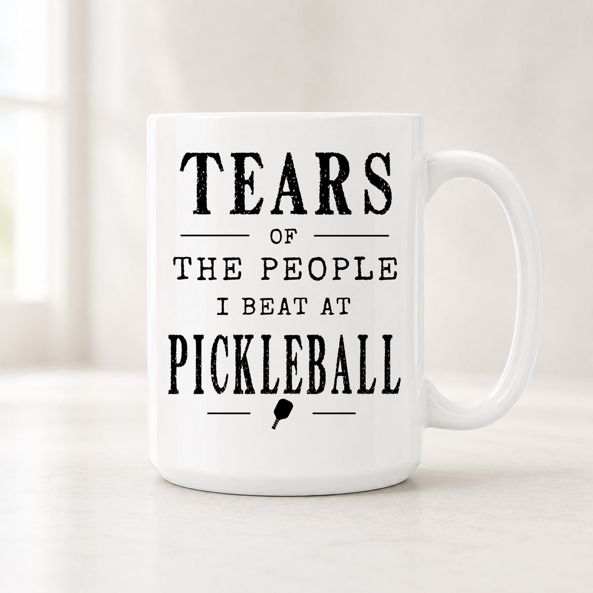 15 oz Tears of the People I Beat at Pickleball mug with bold black vintage lettering and a small pickleball paddle icon