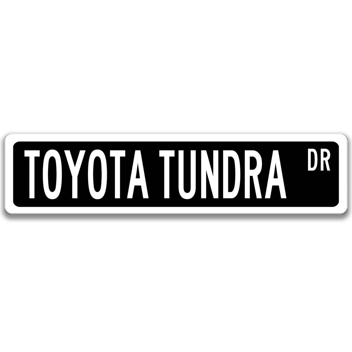 Black street sign with white border, white text reading TOYOTA TUNDRA DR