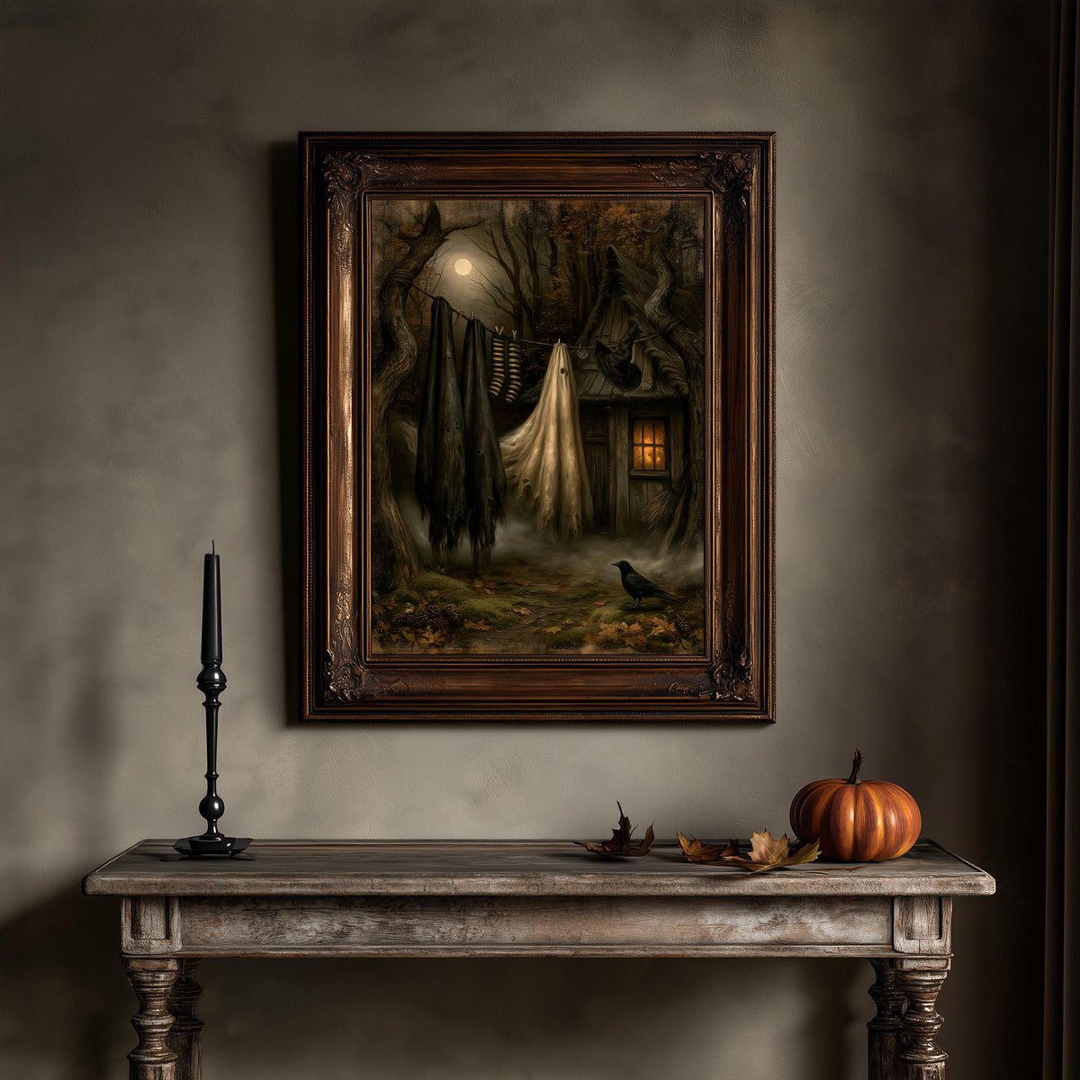 Gothic cottage wall art above a wooden table holding a pumpkin and a candle