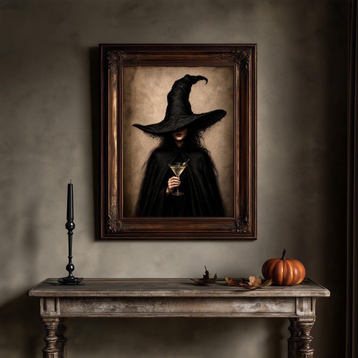Dark academia wall art above a table set with a pumpkin and a single lit candle