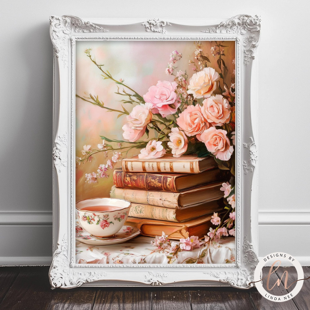 A white ornate frame holds a framed image of a stack of books with a vase of pink roses and a teacup on a table.