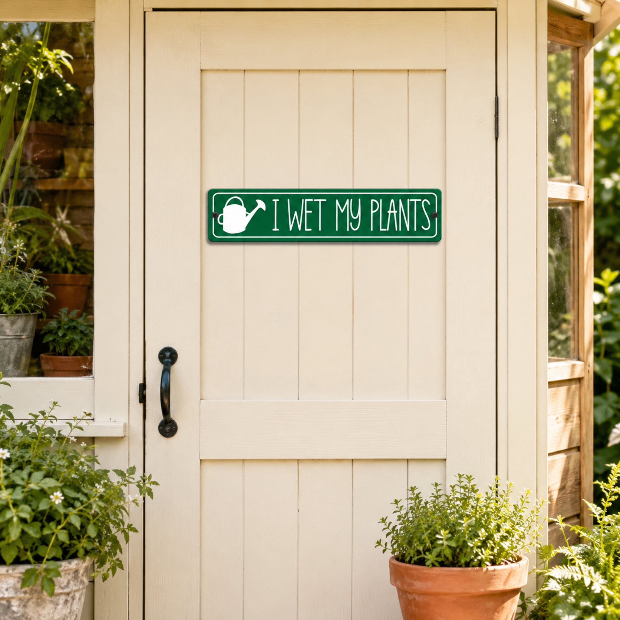 a wooden door with a green sign that reads "I WET MY PLANTS" above it. The door is set in a garden or greenhouse setting, with potted plants visible on either side of the door.