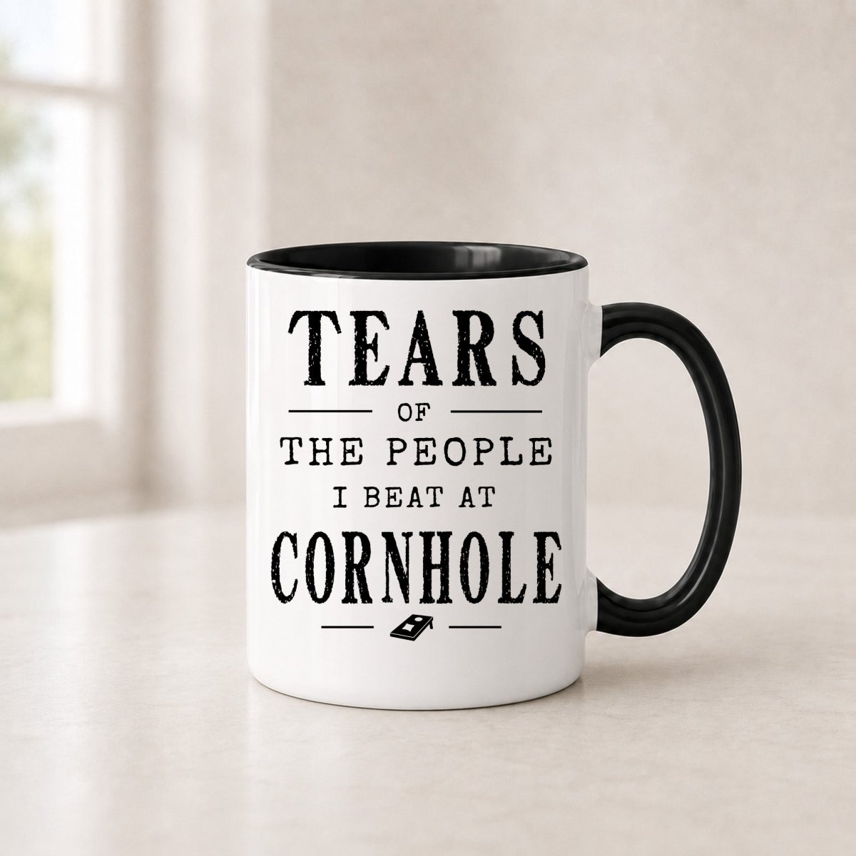 Tears of the People I Beat at Cornhole mug in the 11 oz black handle version with a black interior