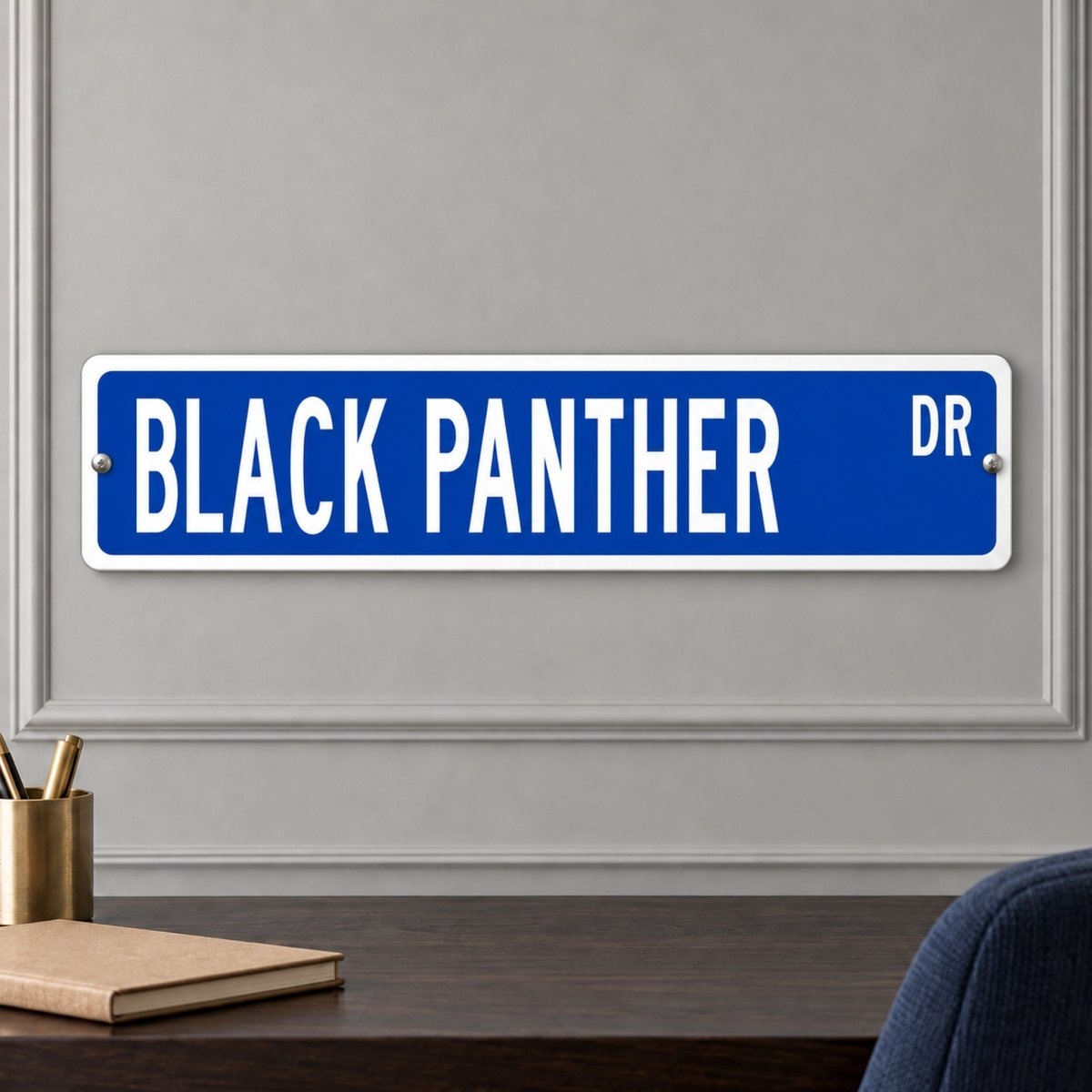 Black Panther street sign with a blue background reading BLACK PANTHER DR, hanging on a wall