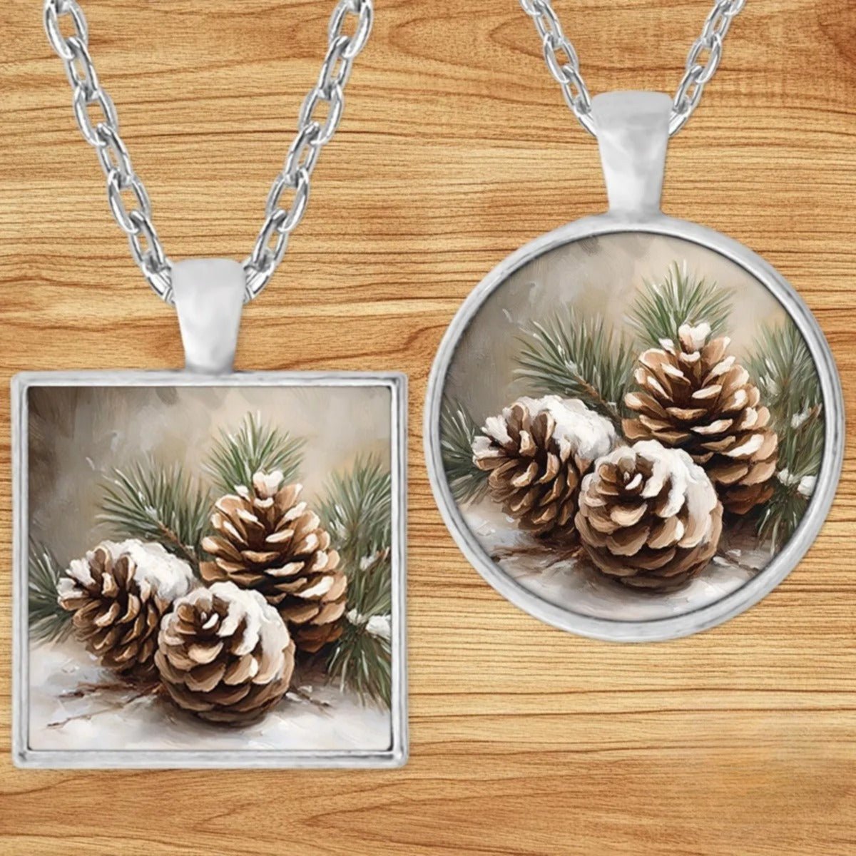 Snowy Pinecone pendant necklace shown in round and square silver charm styles on a wood background