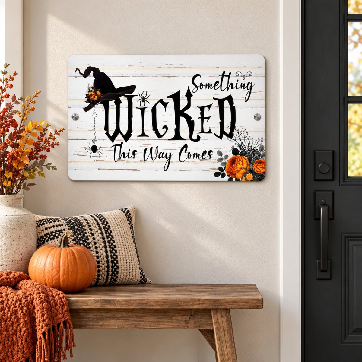 Something Wicked This Way Comes sign above a pumpkin and black and white striped pillow