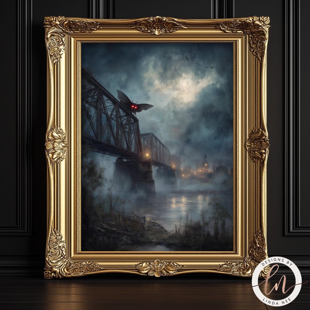 The image is a painting of a bridge with Mothman on it, set against a dark, misty background. The painting is framed in an ornate gold frame and is displayed on a dark wall.