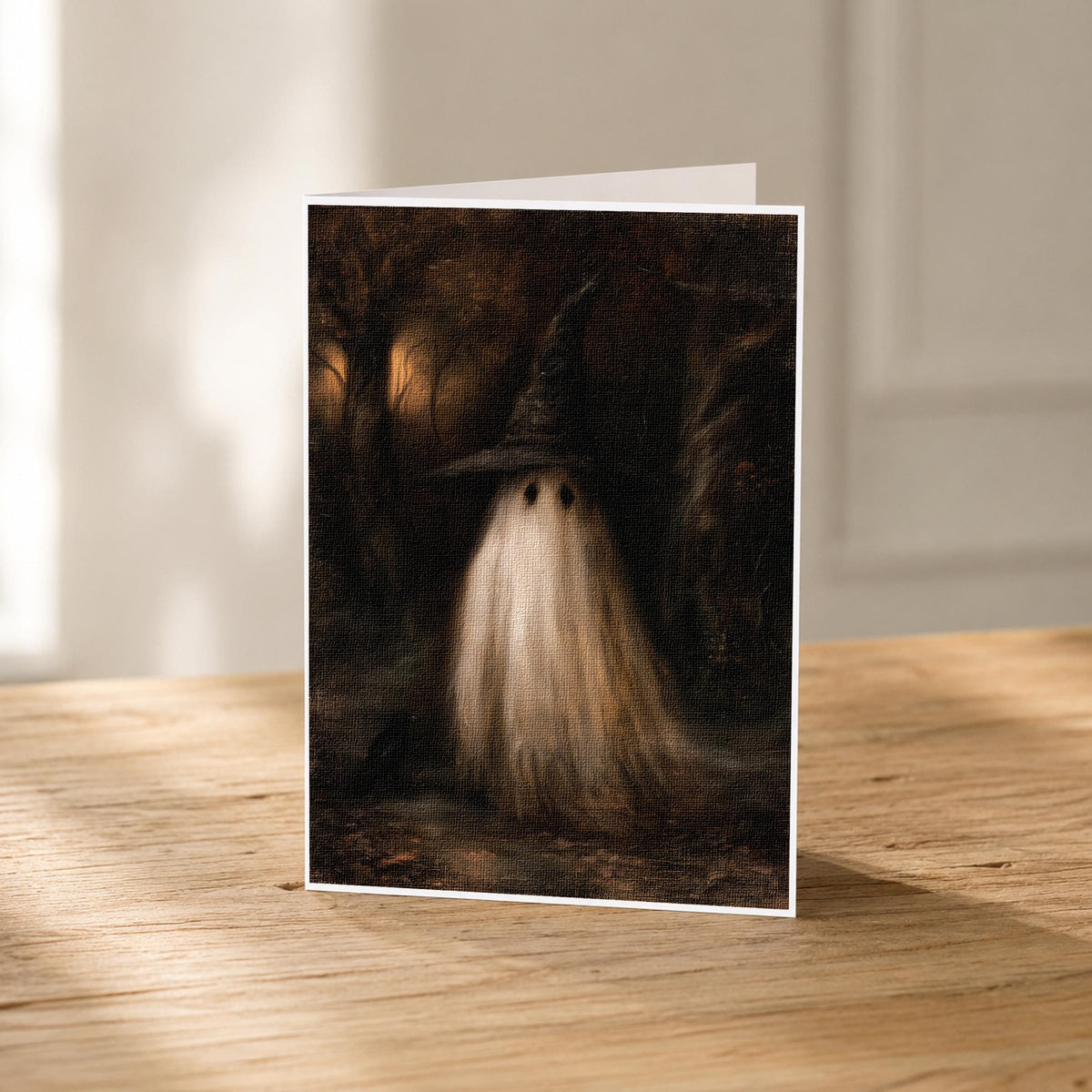 5x7 witch hat ghost blank note card standing upright showing its linen texture and sepia forest artwork