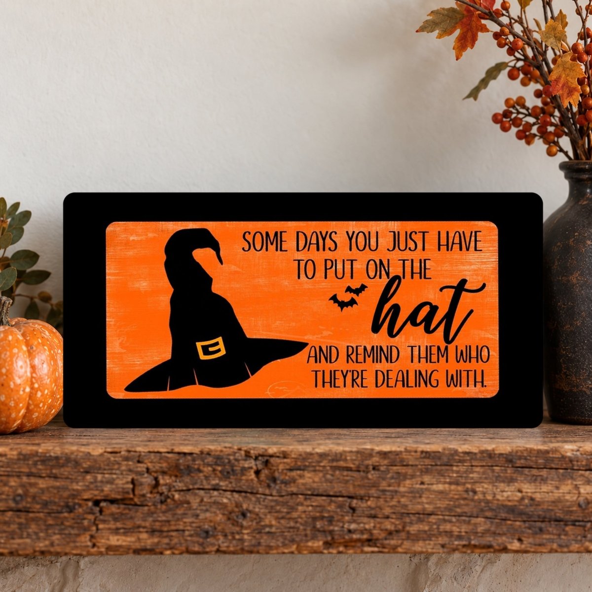 Close view of the Orange Put On the Hat sign artwork