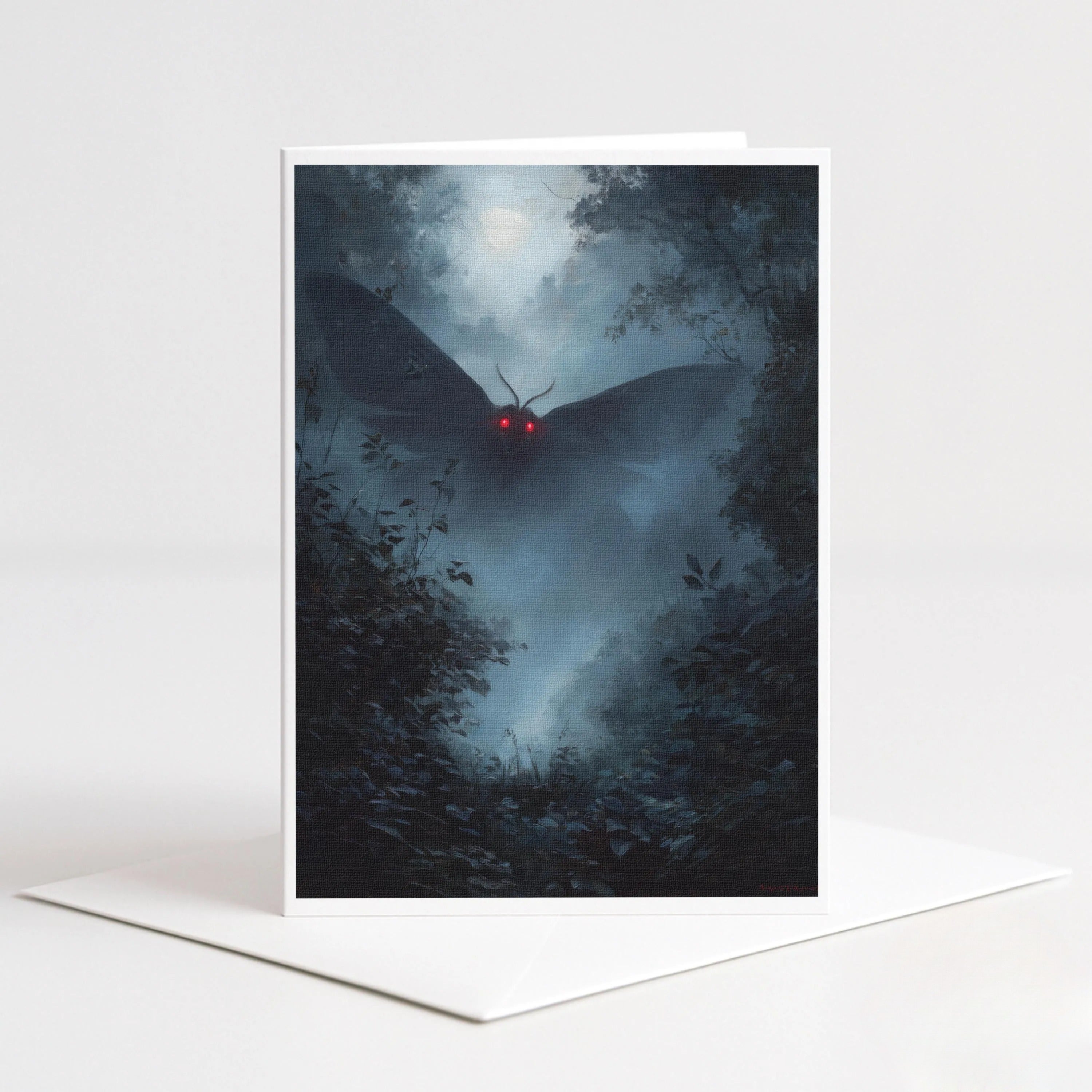 Mothman note card featuring a dark winged cryptid with glowing red eyes flying through a misty blue forest.