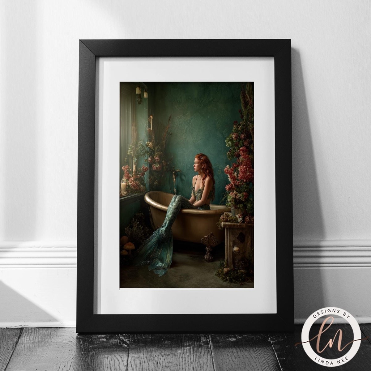 A framed painting depicting a mermaid sitting in a bathtub, surrounded by flowers and plants.