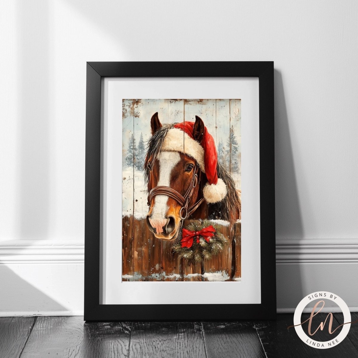 A framed painting of a horse wearing a Santa hat, with a wreath around its neck, set against a snowy background.