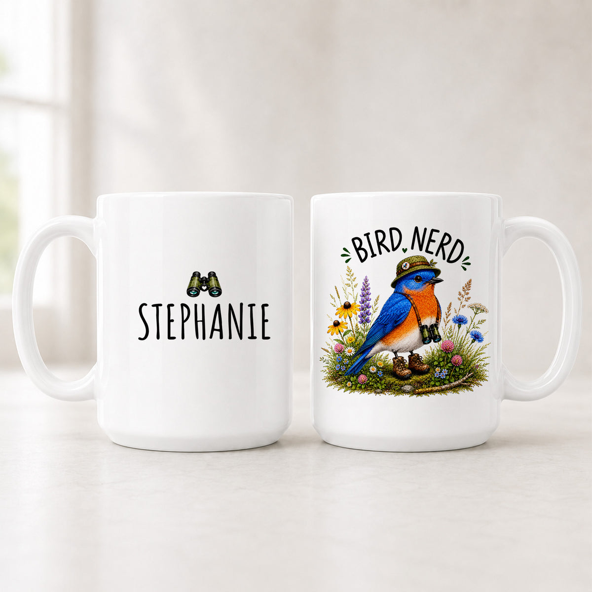 Front and back of the 15 oz Eastern Bluebird Bird Nerd mug, the name STEPHANIE on one side and the bluebird on the other