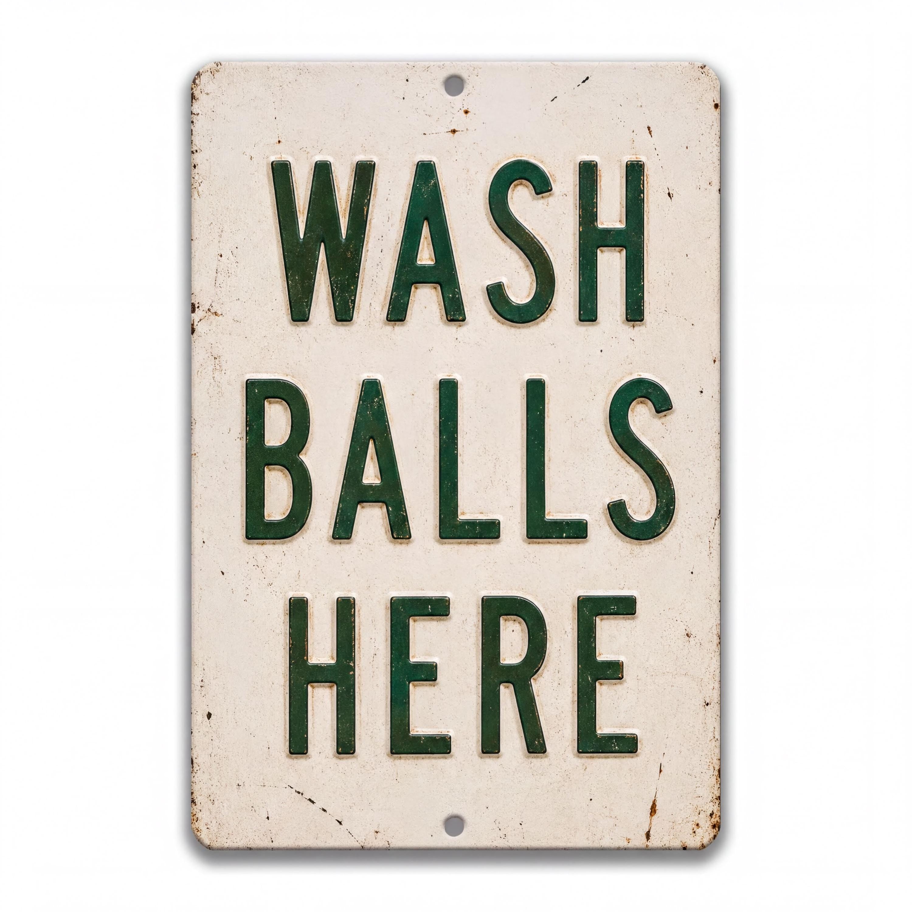 Vintage-style metal bathroom sign with distressed cream background and bold green text reading “Wash Balls Here,” shown as humorous rustic wall decor.