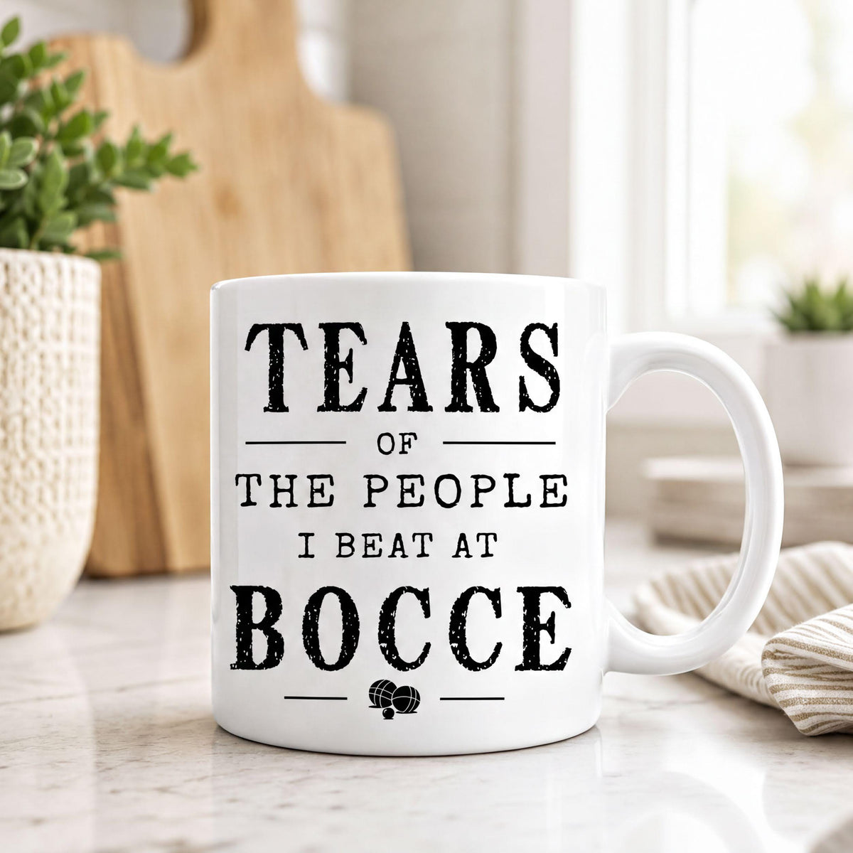 Bocce mug on a kitchen counter, quote reading Tears of the people I beat at bocce in black type