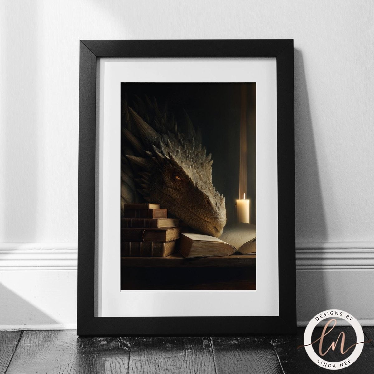 A framed image depicting a dragon-like creature resting on a stack of books, with a lit candle in the background.