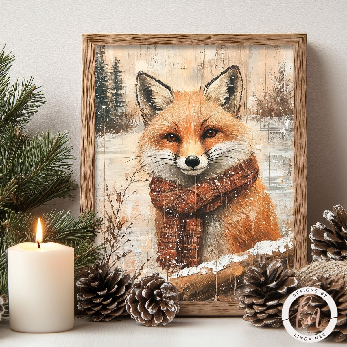 A framed print of a fox wearing a scarf is displayed on a shelf, surrounded by pine cones and a lit candle.