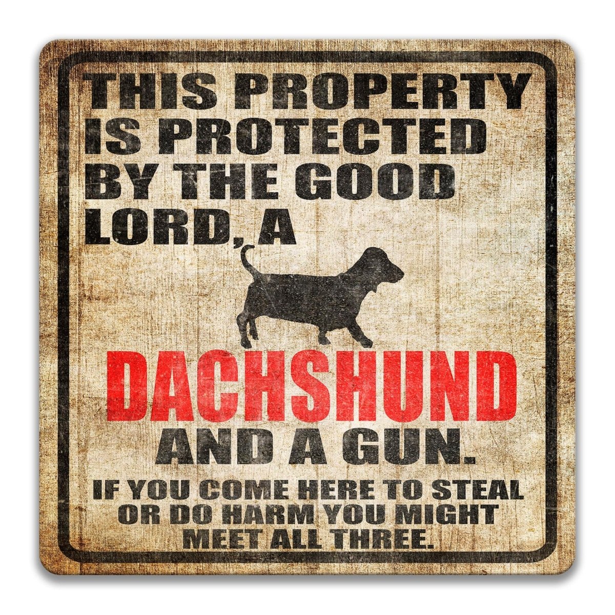 The image is a sign that reads "This property is protected by the good Lord, a Dachshund and a gun. If you come here to steal or do harm you might meet all three."
