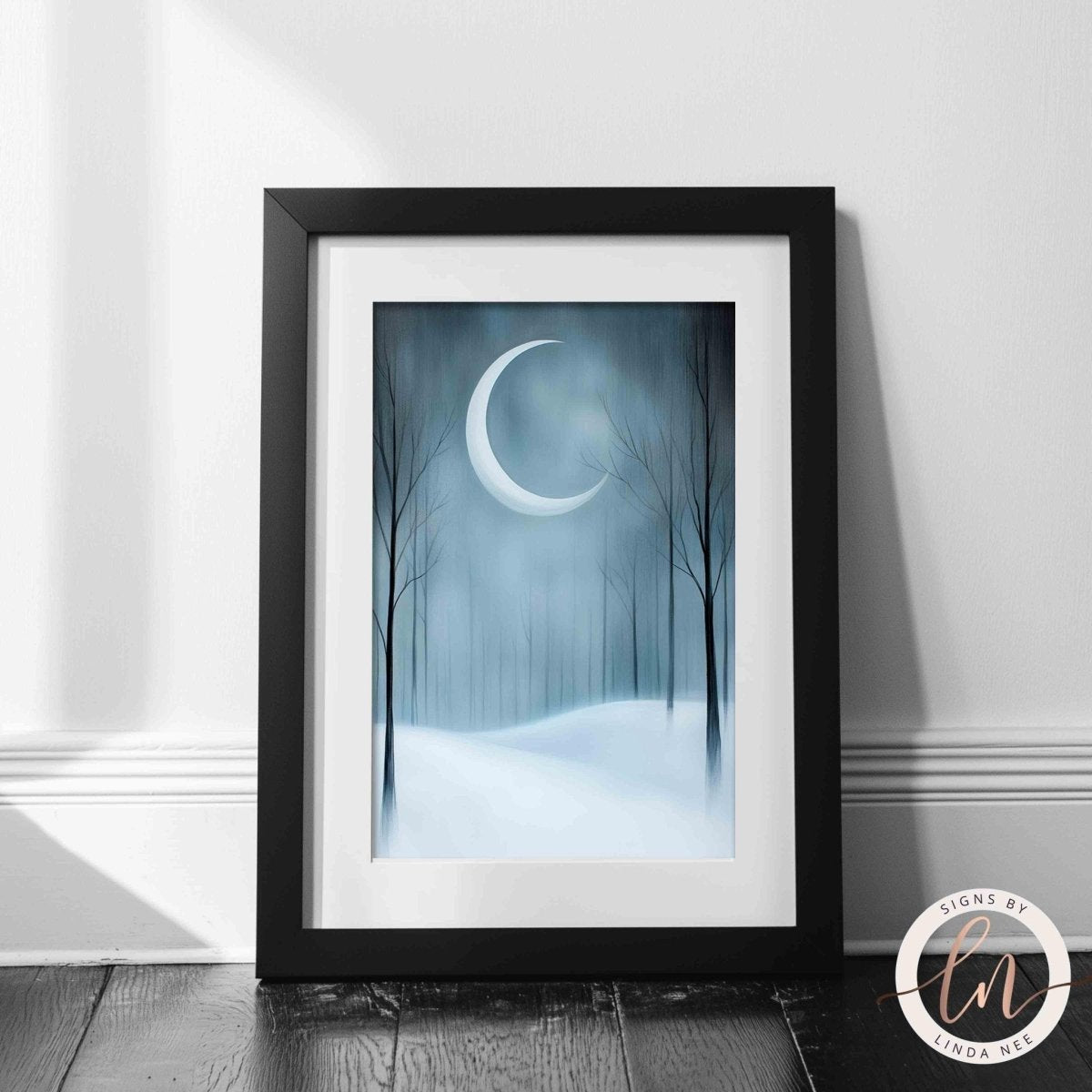 Crescent moon and snowy forest print shown in a plain wall setting