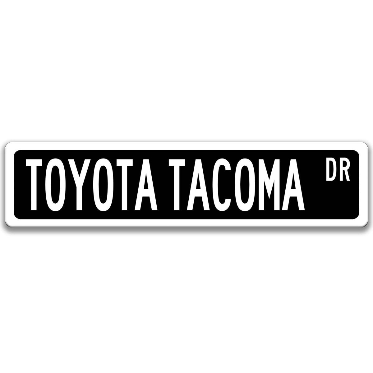Black street sign with white border, white text reading TOYOTA TACOMA DR