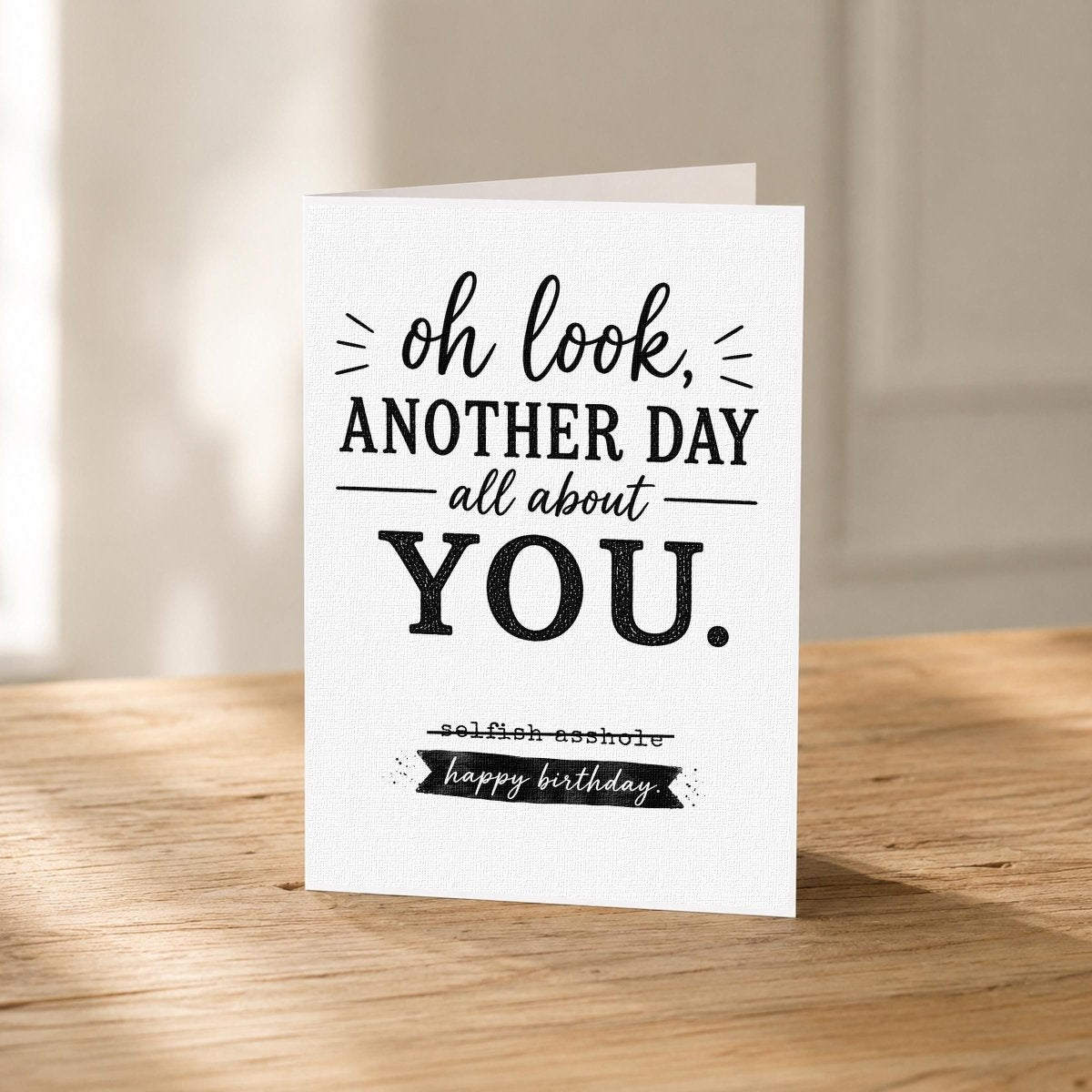 Close-up of the Selfish Birthday Card for Best Friend showing the crossed-out punchline in bold type.