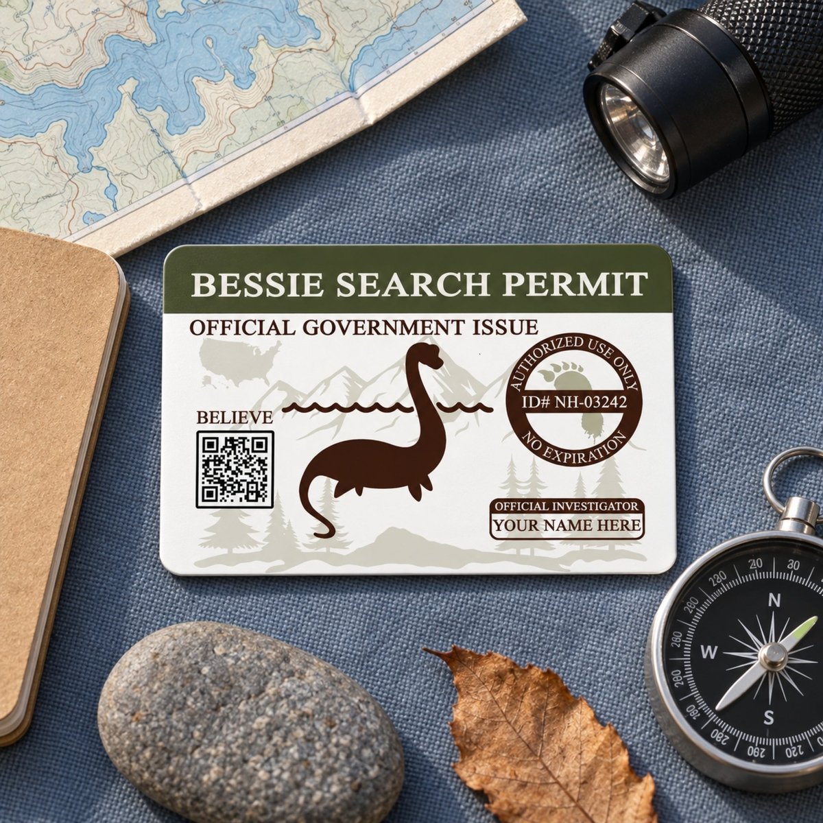 a Bessie Search Permit, a fictional government-issued identification card, along with various travel-related items such as a map, compass, flashlight, and leaf.