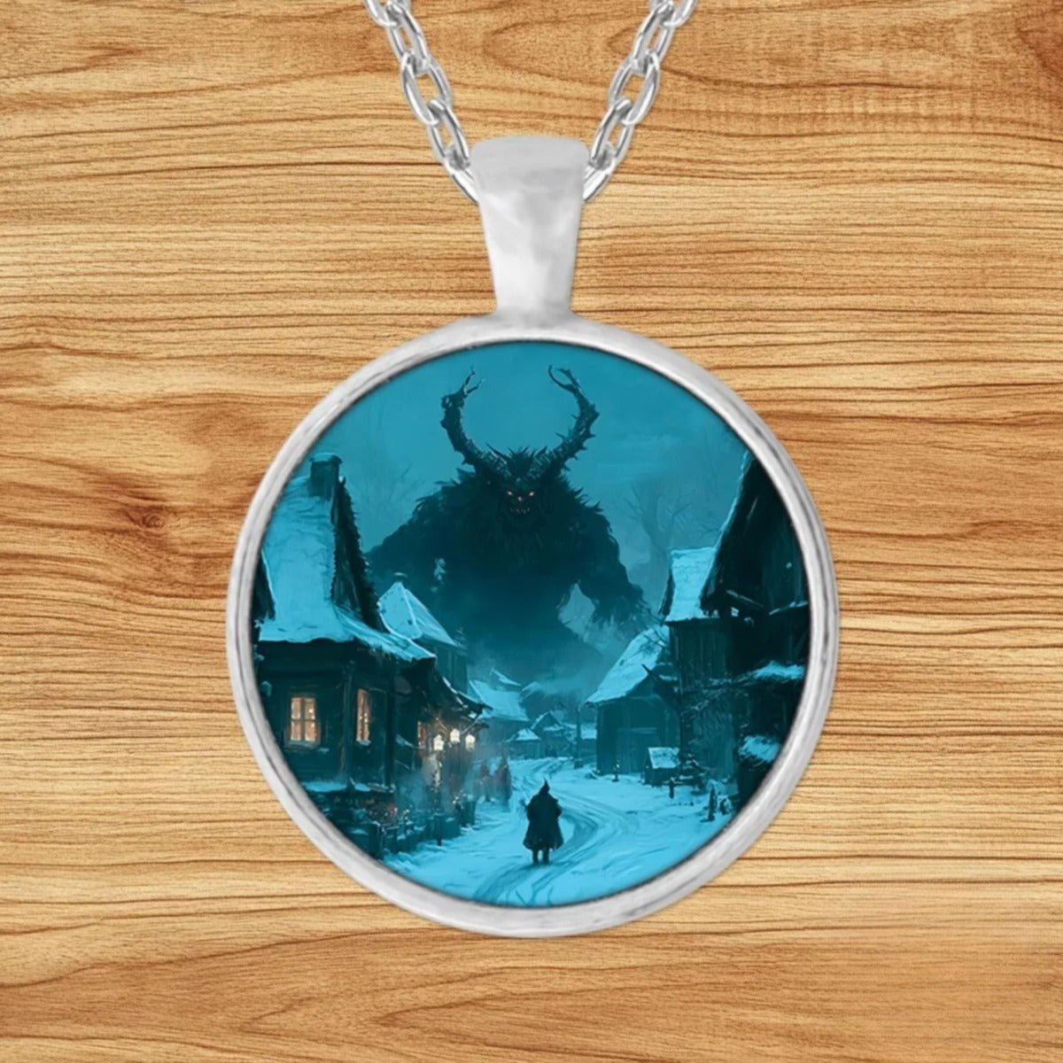 Round silver charm pendant necklace featuring the horned Krampus looming over a snow-covered European village beneath a moonlit sky