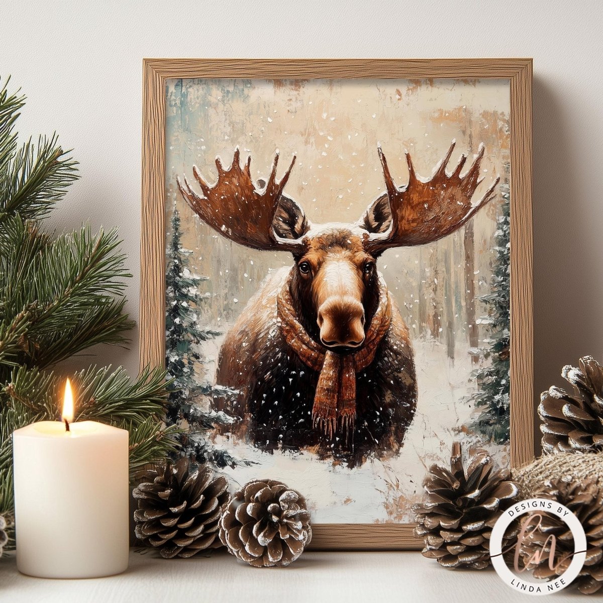 A framed painting of a moose with large antlers, surrounded by pine cones and a lit candle, creating a cozy winter scene.