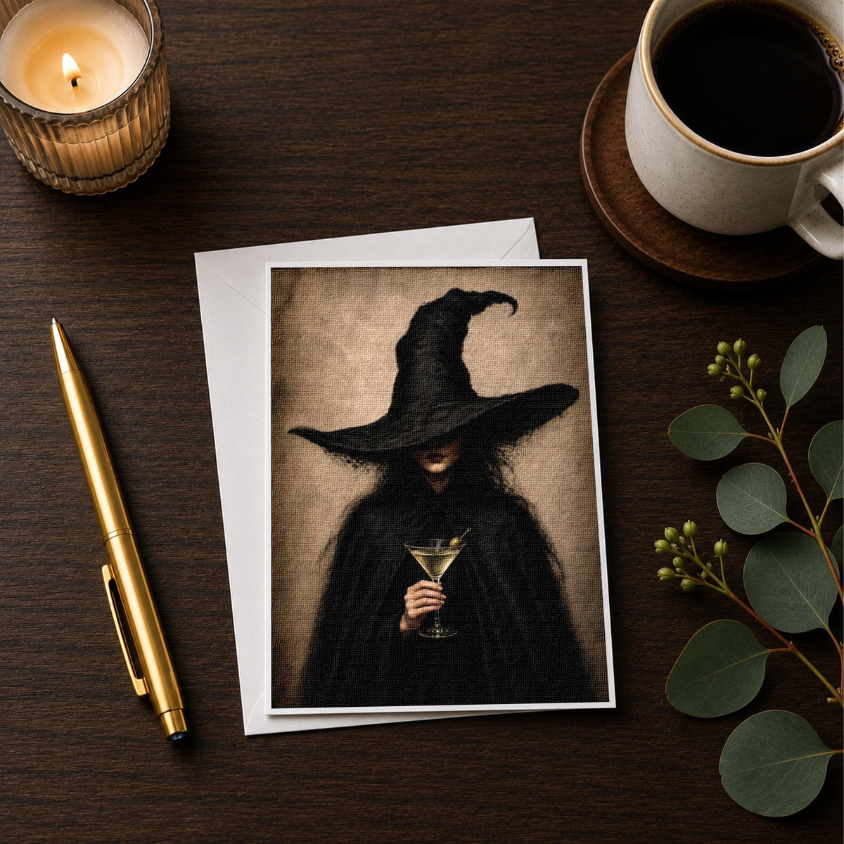 Witch martini note card styled on a wooden desk with a candle and a coffee cup