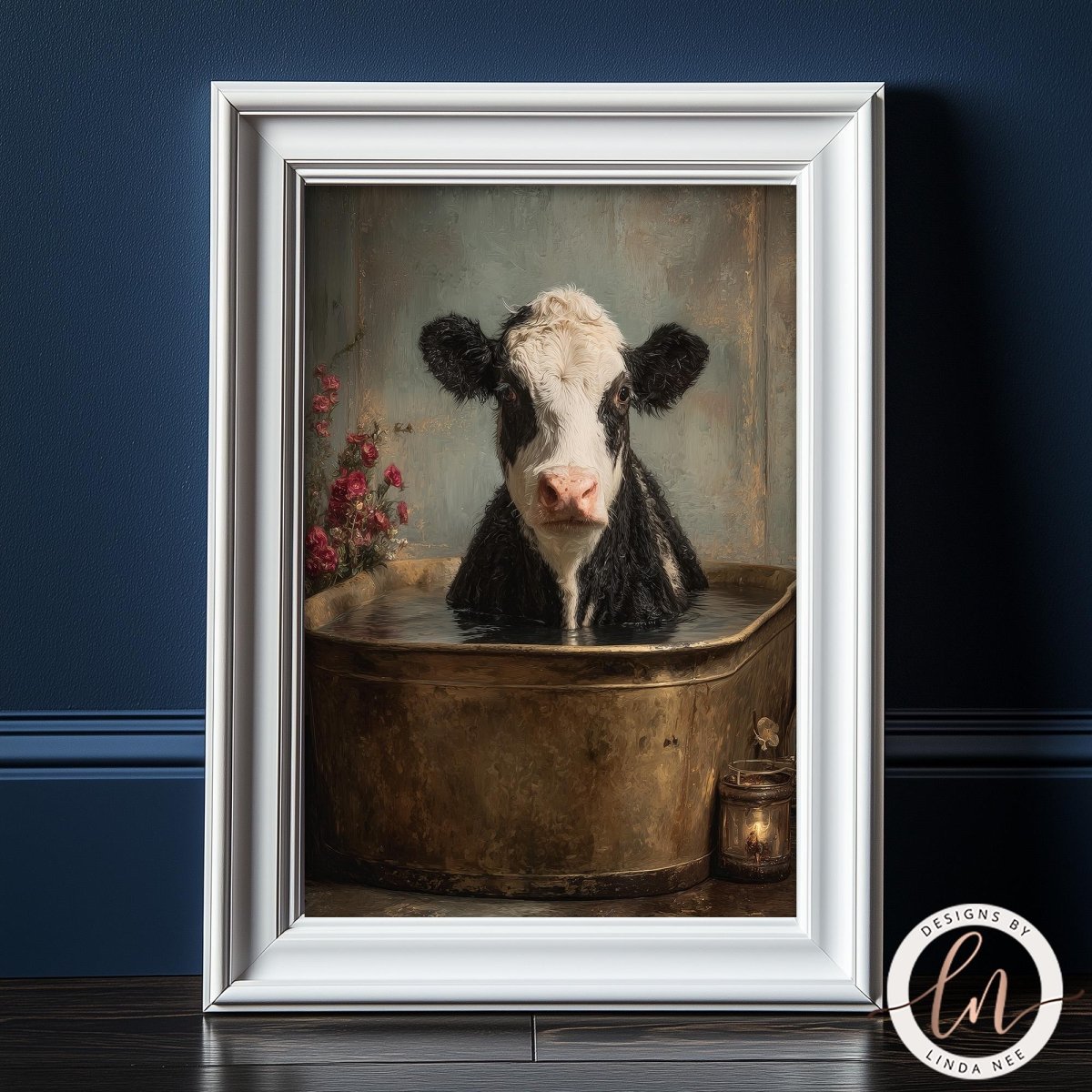 A framed painting depicting a black and white cow sitting in a metal tub filled with water, with a vase of flowers on the side.