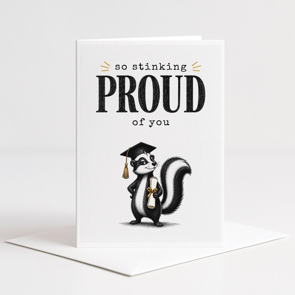 A graduation card with a cartoon image of a skunk wearing a graduation cap and holding a diploma.