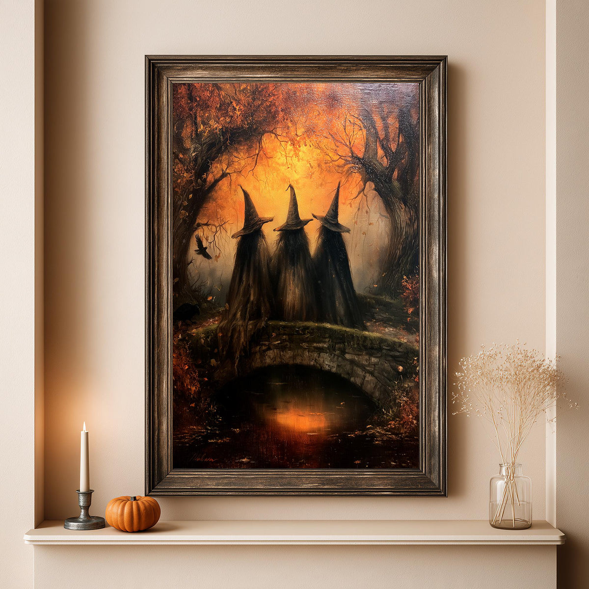 Autumn witch print above a shelf set with a pumpkin and a lit candle