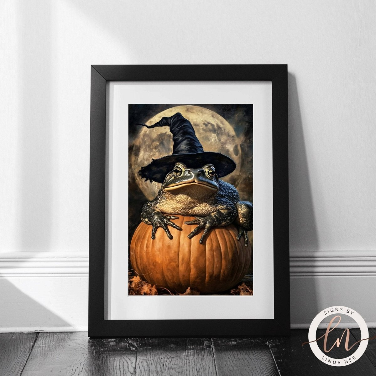 Toad in a witch hat on a pumpkin shown with a full moon behind